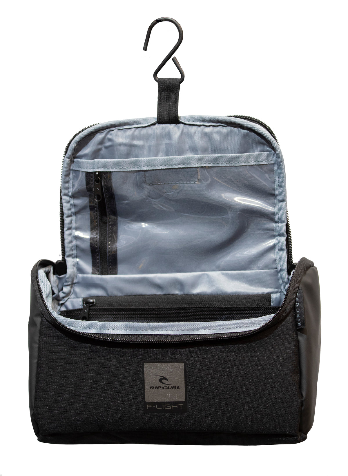 The Rip Curl F-Light Toiletry Midnight bag, made of water-resistant polyester, includes a hook for hanging and has multiple compartments with a clear zippered pocket. The exterior showcases a text logo with a subtle design.