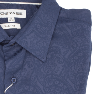 Close-up of a folded Gerase Paisley Print Dress Shirt, featuring branded labels and a striking paisley design. This medium-sized (39-40) Body Fit shirt is crafted from soft Bamboo Fibre and neatly buttoned up.