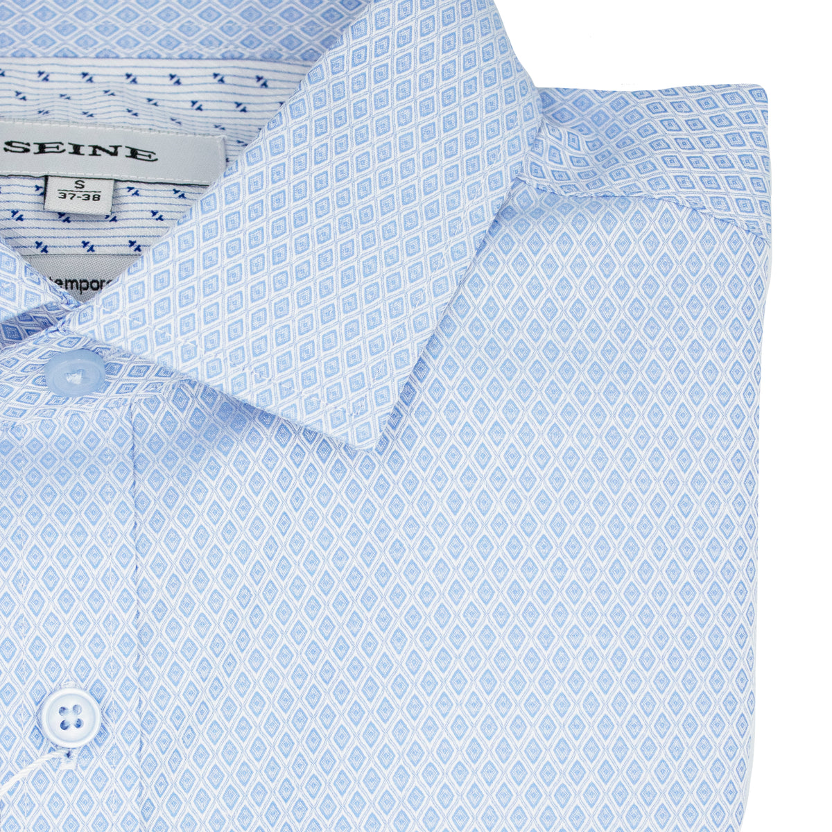 A close-up of the Seine Dress Shirt reveals a folded light blue contemporary fit shirt with a small geometric diamond pattern, featuring front buttons and a visible collar label.