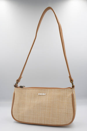 The Rip Curl Sunset Palms Shoulder Bag features a stylish beige woven design with a long tan leather strap, compact rectangular shape, and small metal logo on the front. It's displayed against a plain white background, making it ideal for casual outings with its beachy vibe.