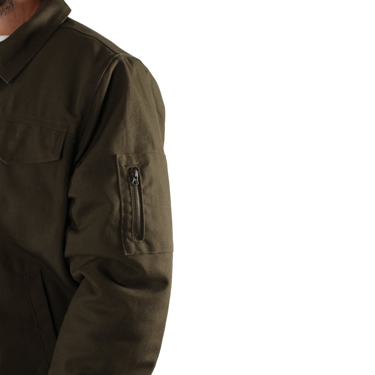 A person wearing the Ringers Western Mildura Sherpa Bomber Jacket in olive green, featuring durable water-resistant fabric and a zipper pocket on the left sleeve. The image is cropped to show only the upper torso and part of the left arm, emphasizing the jacket's sherpa lining and intricate details against a plain white background, showcasing Ringers Western quality.