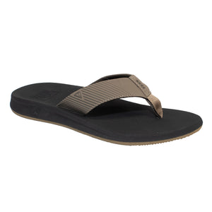 The REEF Phantom II is a tan and black flip-flop sandal featuring an EVA footbed, wide fabric strap, and textured surface for arch support and casual style.