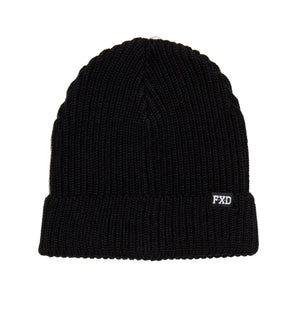 The FXD CP-9 Beanie is a black knitted beanie hat with a folded brim made from recycled polyester. It features a rib knit design and includes a small white tag on the front with "FXD" embroidered on it, giving it a classic, cozy appearance.