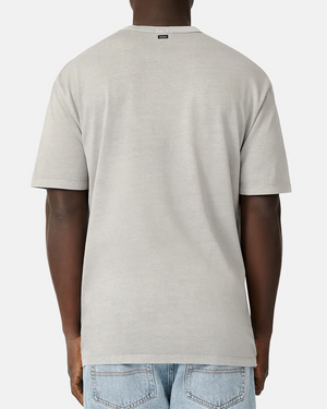 Rear view of a person in Industrie The Del Sur Tee, a plain gray casual oversized fit, paired with light blue jeans against a plain white background.