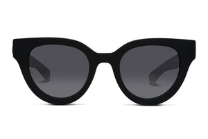 The Liive Rumble Polar Sunglasses feature a pair of black cat-eye lenses with dark tinting. The polycarbonate frames boast sharp, angular edges that curve slightly upward at the outer corners. These sunglasses provide UV protection while offering a stylish and modern appearance.