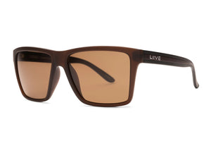 The Liive X Sabotage X Polar Sunglasses boast a matte brown frame with rectangular brown lenses, blending modern minimalism and lightweight comfort. Dark temples transition to a beige gradient near the hinge, featuring the "LIIVE" brand name in white.