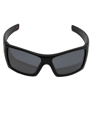 The Oakley Batwolf Polarized sunglasses feature black wraparound lenses with dark tinted Prizm for full eye protection. The sleek frame offers a modern touch, slightly curved around the temples for style and functionality.