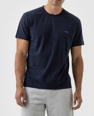 A person stands against a plain background in a Rodd & Gunn The Gunn T-Shirt, featuring a small logo on the chest. The dark blue, Australian Cotton casual tee complements their light gray sweatpants, with the individual visible from the waist up.