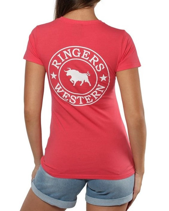 A person in a pink "Ringers Western Womens Signature Bull Classic Fitted T-Shirt" with a bull logo on the back, paired with light blue denim shorts. They have long hair, and the image taken from behind highlights the comfortable and casual design of the t-shirt.