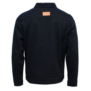 Back view of the Ritemate Pilbara Jacket in black denim, showcasing a small brown leather patch at the upper back with an unreadable logo and text. The stylish jacket features a collar, long sleeves, and adjustable buttoned waist tabs.