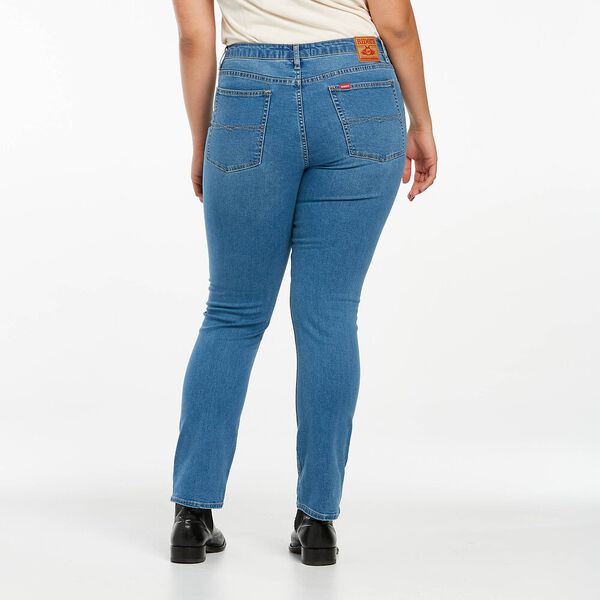 A person wears Riders Classic Mid Straight Jeans, featuring two back pockets and a brown waistband patch, paired with a white T-shirt and stylish black shoes, standing against a light background.