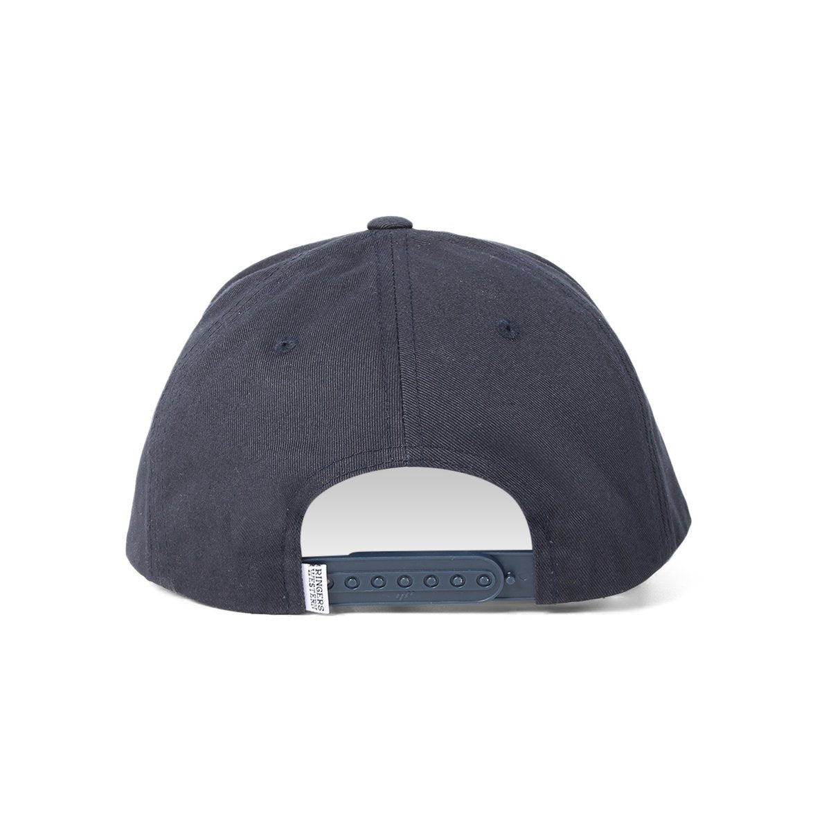 The dark blue Ringers Western Grover Baseball Cap is shown from the back, featuring an adjustable strap with snap buttons for size adjustment. The tag near the strap, displaying Ringers Western branding, is partially visible. The fabric appears smooth, and the cap boasts a simple design without any visible logos or embellishments.