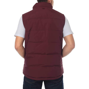 A person is shown from the back wearing a Ringers Western Horsham Puffer Vest in maroon, featuring an adjustable waist, over a light gray t-shirt and dark blue jeans. They have short hair and are standing against a plain white background.