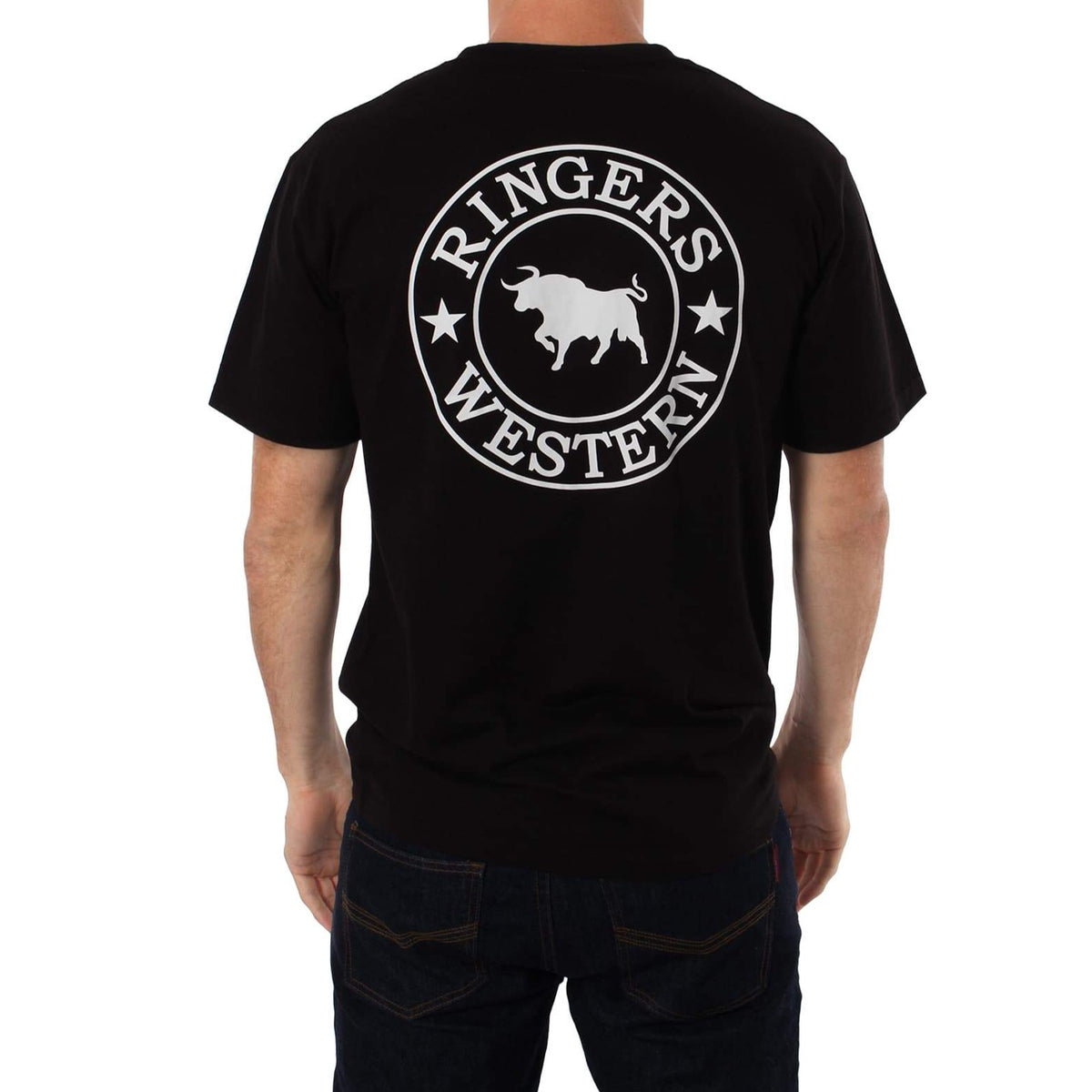 A person wearing a black Ringers Western Signature Bull Classic T-Shirt, which features the logo in white. The design showcases a silhouette of a bull within a circular emblem, flanked by two stars. The comfortable T-shirt perfectly complements the casual stance as the person stands with their back facing the camera.