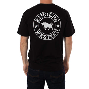 A person wearing a black Ringers Western Signature Bull Classic T-Shirt, which features the logo in white. The design showcases a silhouette of a bull within a circular emblem, flanked by two stars. The comfortable T-shirt perfectly complements the casual stance as the person stands with their back facing the camera.