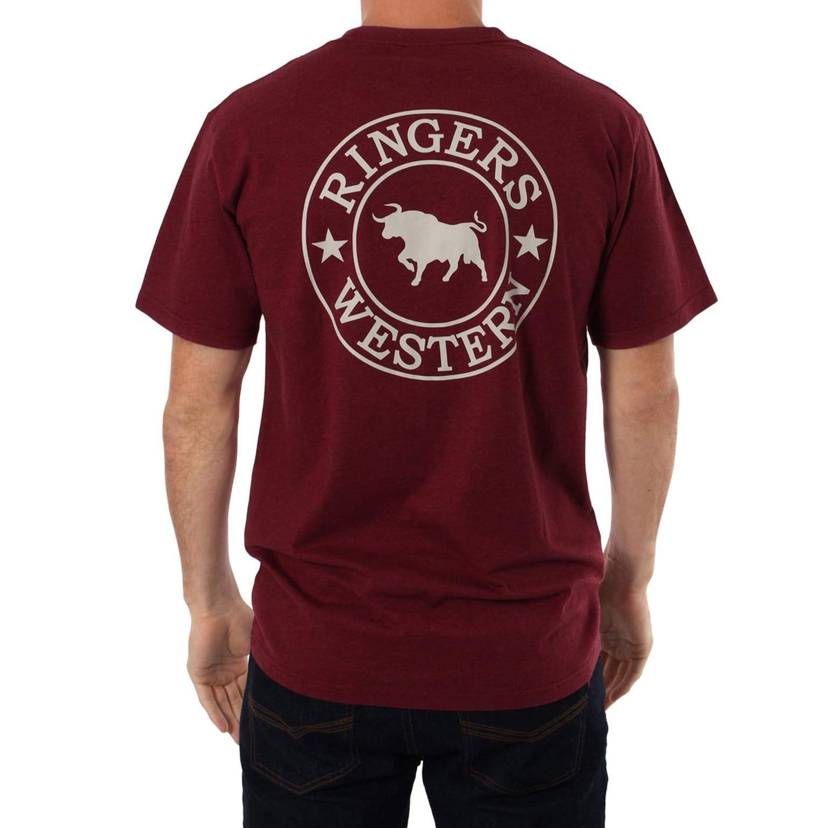 A person is wearing the Ringers Western Signature Bull Classic T-Shirt, a comfortable maroon crew neck featuring the "Ringers Western" logo on the back with a white bull silhouette flanked by stars. They're also sporting dark jeans against a plain white background.