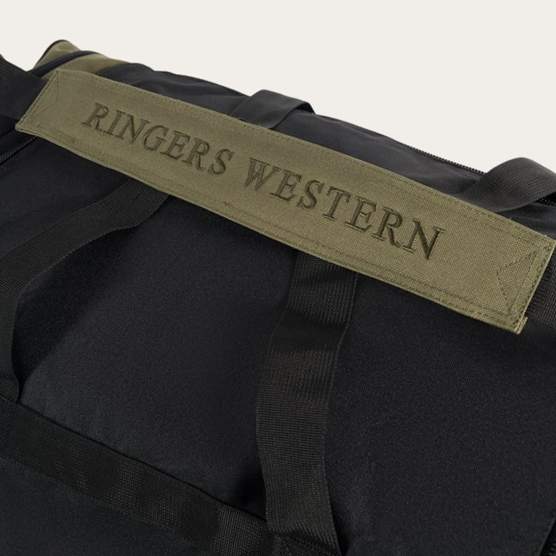 The Ringers Western Rider Sports Bag is a black sports bag featuring dark green straps and handles. The top strap is stylishly embroidered with "RINGERS WESTERN" in green uppercase letters, making it both fashionable and durable, perfect for any adventure.