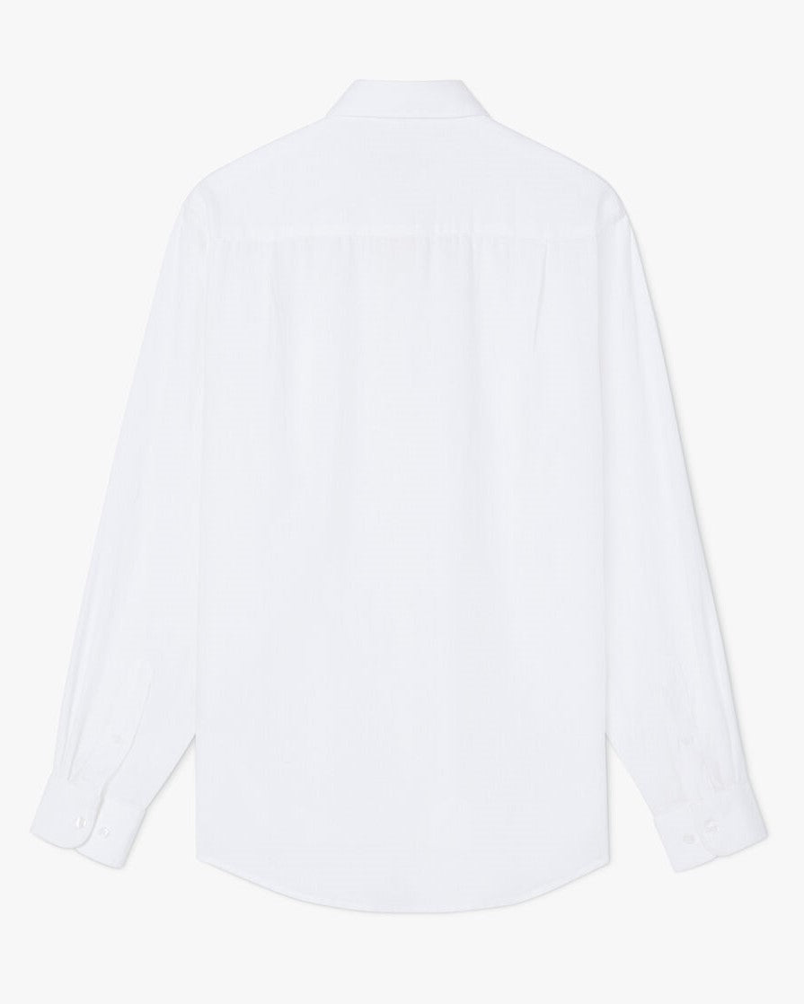 The RM Williams Collins Shirt is shown from the back in plain white, featuring long sleeves, a curved hem, buttoned cuffs, and a simple collar.