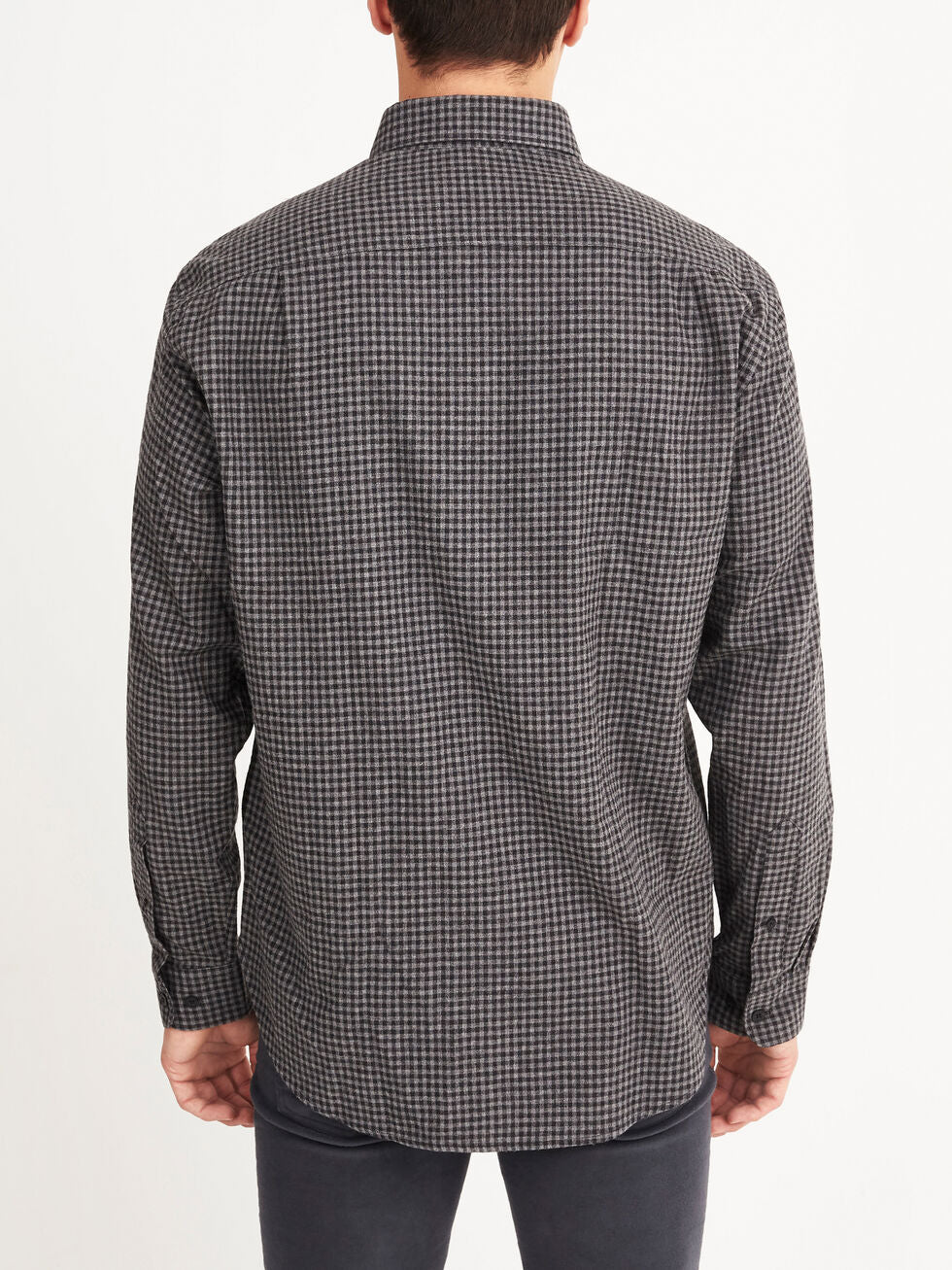 A man is seen from behind wearing the RM Williams Collins Shirt, a long-sleeved button-up with a small black and gray check pattern in soft brushed cotton, against a plain white background.