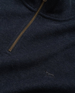 Close-up of a Rodd & Gunn Alton Ave Sweat, a dark blue 100% cotton half zip sweater with a gold zipper slightly open at the collar and a subtle embroidered kangaroo logo near the bottom right.