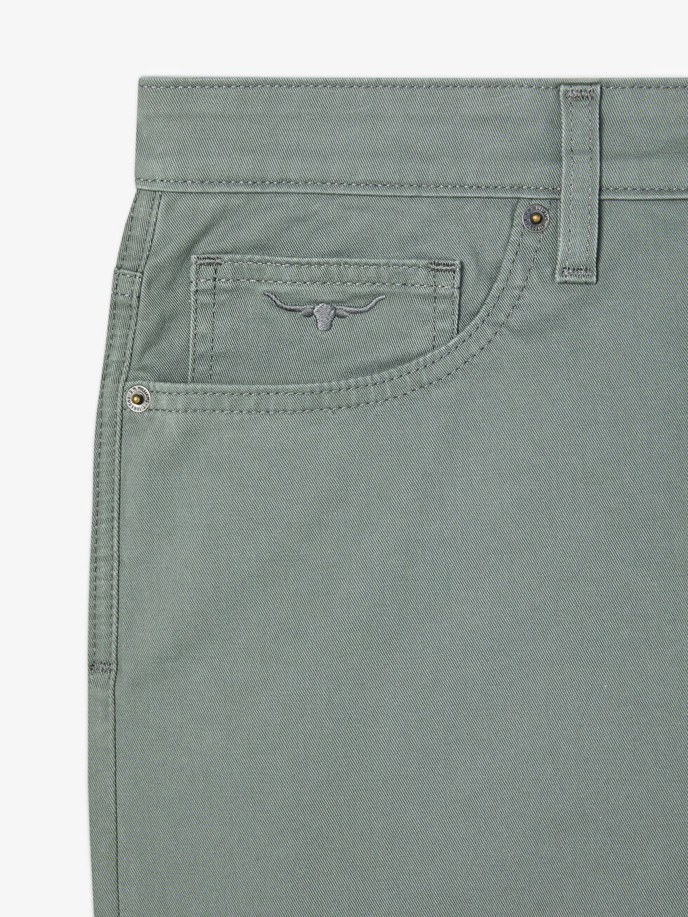 Close-up of a gray-green denim section featuring the waist, belt loops, button, and small front pocket. The stitched bull logo decorates the pocket with metal rivets at seams on a white background. Ideal for fans of RM Williams Nicholson Short quality.