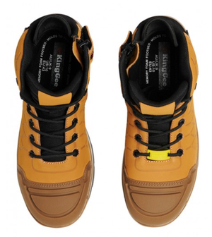 A pair of King Gee Quantum Safety Boots in light brown, featuring black laces and yellow accents as seen from above. The insoles display the "KingGee" logo. These high-top boots come with padded collars and shock-absorbing impact technology, guaranteeing comfort and style in every step you take.