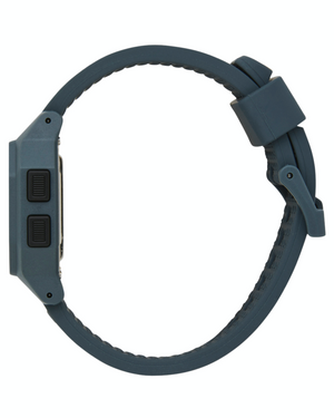 Side view of the Rip Curl Atom Digital Watch in dark blue, featuring a rubber strap with a buckle clasp and two buttons on the left side of its rectangular waterproof face.