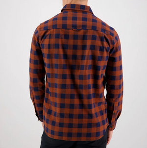 A man wearing the comfortable Swanndri Taranaki Tailor Shirt made from 100% cotton plaid fabric.