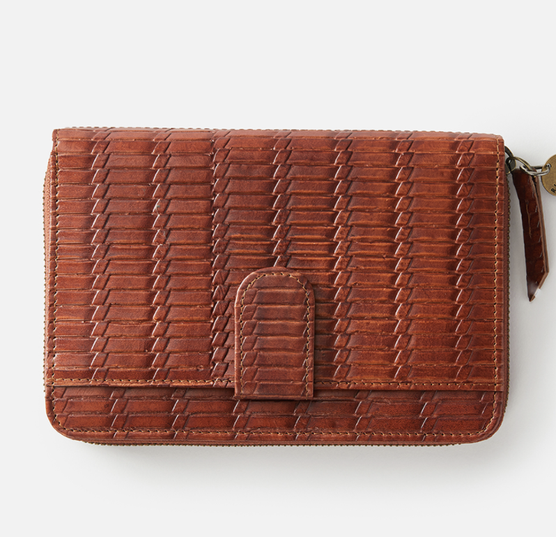 The Rip Curl Hermosa RFID Leather Wallet features a textured woven pattern, brown finish, secure snap closure, and a right-side zipper. It combines style with RFID protection against digital theft, highlighted on a plain white backdrop.