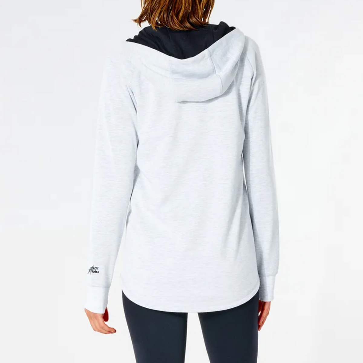 A person is seen from the back wearing a Rip Curl Anti Series Flux II Zip, highlighting its Durable Water-Resistant fabric. The hoodie has a black hood and is paired with dark leggings on a white background. The phrase "Built for Athletes" is near the lower hem, combining style with winter functionality.