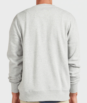 A person is seen from the back wearing the Academy Brand College Crew in light gray, highlighting its long sleeves and ribbed cuffs against a simple, uncluttered background.