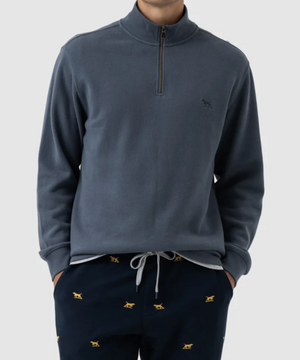 A person is wearing the Rodd & Gunn Alton Ave Sweat, a gray, 100% cotton pullover with a half-zip collar, paired with navy blue pants featuring small yellow embroidered dog patterns. The outfit exudes a casual and comfortable style against a plain, light-colored background.