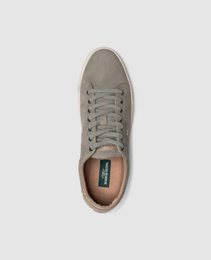 The Rodd & Gunn Endeavour Spirit Sneaker, a single gray nubuck leather shoe with a white rubber sole and gray laces, showcases a green insole inscribed with "RODD & GUNN" in white for added comfort. The sneaker is presented from a top-down perspective against a white background.