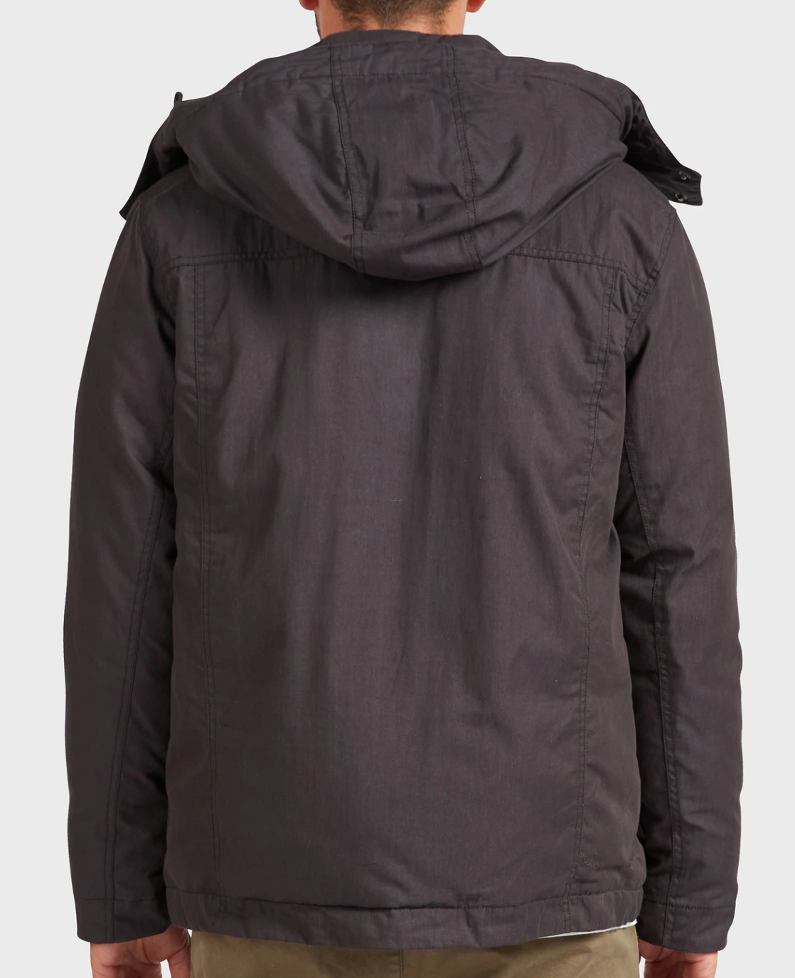 A person wearing the Academy Brand Miller Jacket in dark gray is shown from the back. The stylish, comfortable jacket has visible seams, a relaxed fit, and is paired with light-colored pants.