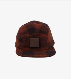The Swanndri Wentworth Valley Cap, made from brown and black plaid Swanndri wool, includes a front logo on a black patch. It's elegantly showcased against a plain white background.