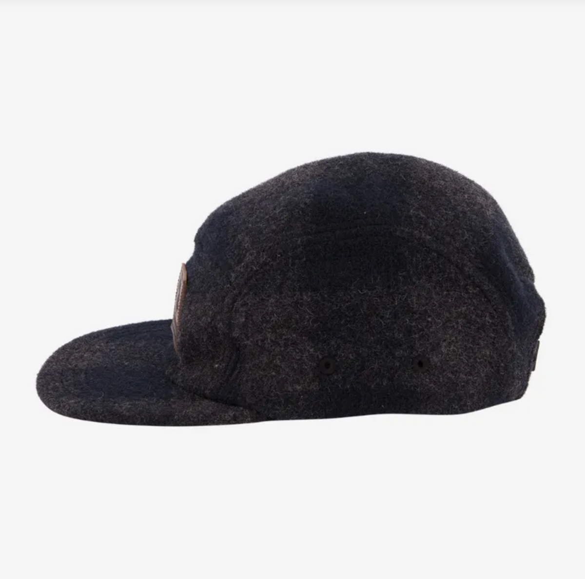 Side view of the Swanndri Wentworth Valley Cap, made from dark gray wool, showcasing its curved brim and ventilation holes on the side panel, set against a white background.