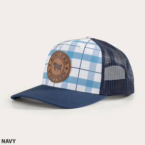 Introducing the Ringers Western Flint Trucker Cap: a navy blue trucker hat with a stylish blue and white checkered front panel. It features a distinctive brown leather patch embossed with a bull and the text "Ringers Western." The back is crafted from navy blue mesh and includes an adjustable strap for the perfect fit. Text in the bottom left corner reads "NAVY.