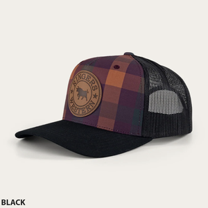 The Ringers Western Flint Trucker Cap boasts a plaid pattern in hues of purple, red, and orange on the front, matched with a black mesh back and black bill. A circular leather patch with an embossed bull and the text "Ringers Western" adorns the front, while an adjustable strap guarantees a perfect fit.