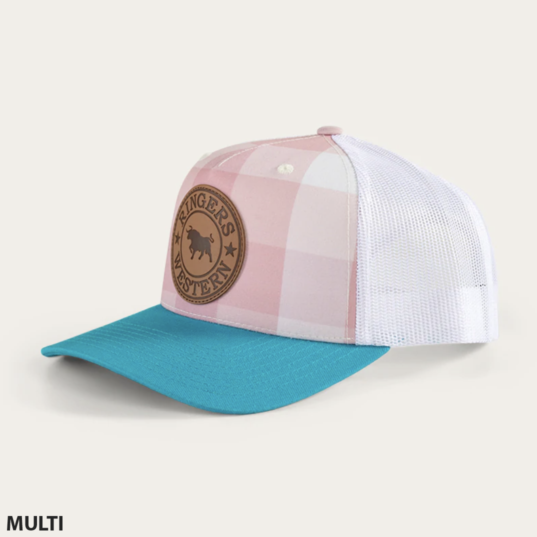 The Ringers Western Flint Trucker Cap features a plaid-patterned design with a pink and white checkered front panel, teal blue brim, and white mesh back. The front showcases a circular brown leather patch embossed with "Ringers Western" and a buffalo silhouette. It also includes an adjustable strap for the perfect fit.