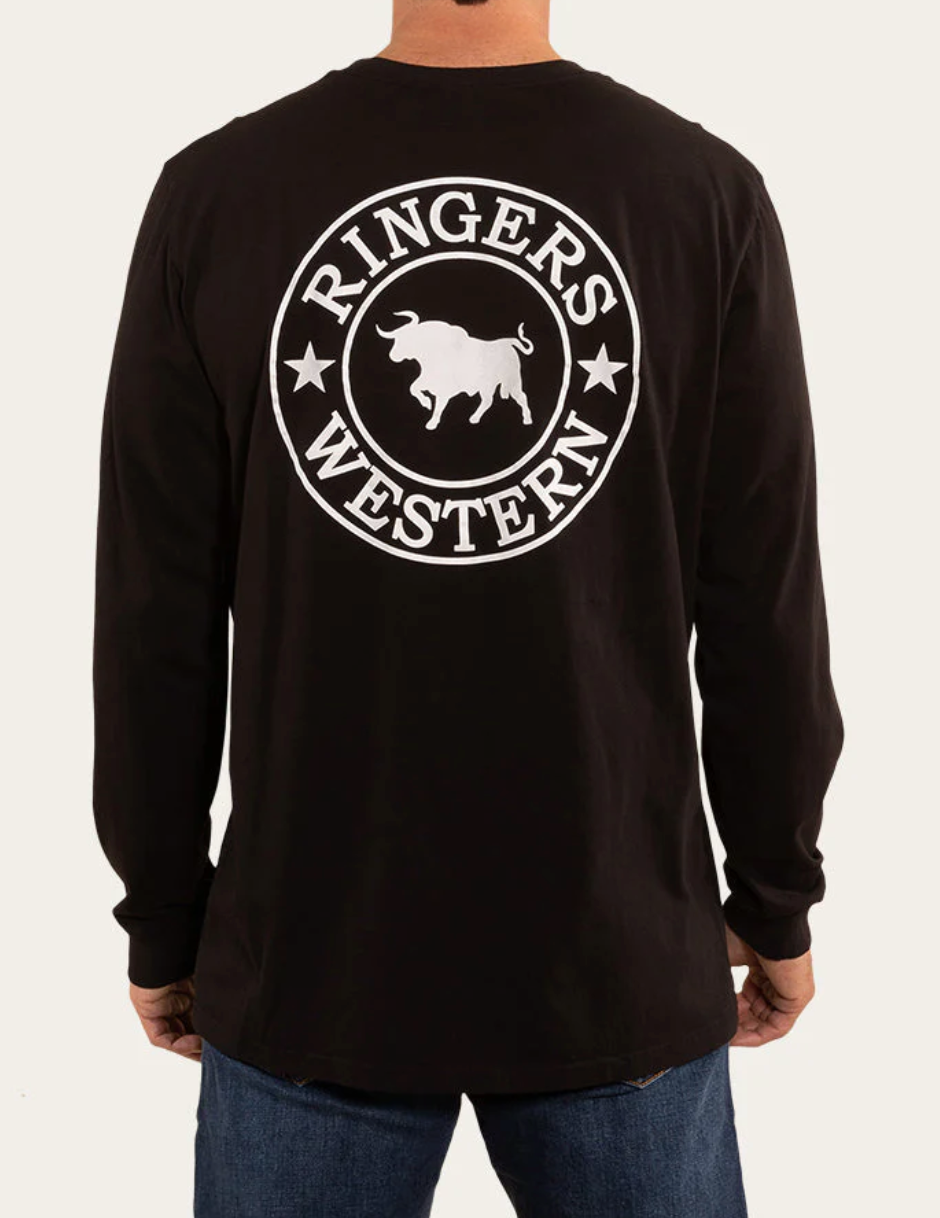 A person dressed in a black Ringers Western Signature Bull Loose Fit Long-Sleeve T-Shirt, featuring "Ringers Western" written in white on the back surrounding a graphic of a bull, stands against a plain background while wearing blue jeans.