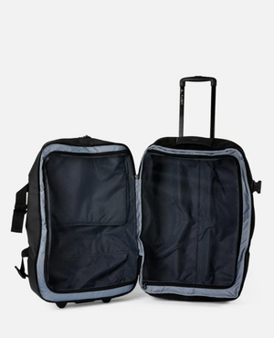 Open the Rip Curl F-Light Global 110L Midnight travel bag with an extended telescopic handle. It features a spacious interior and mesh divider for ample storage, with a sleek exterior design that's perfect for minimalist travelers.