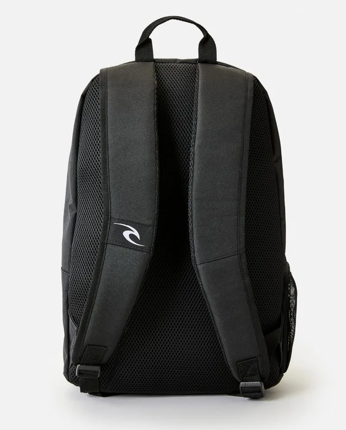 The Rip Curl Evo 24L Icons of Shred Backpack in black is shown from the back, highlighting its padded shoulder straps and a small wave logo on one of the straps. The backpack offers enhanced comfort and ventilation with mesh padding on the back panel. Inside, a dedicated laptop section ensures your tech stays secure, and a top handle provides convenient carrying options.