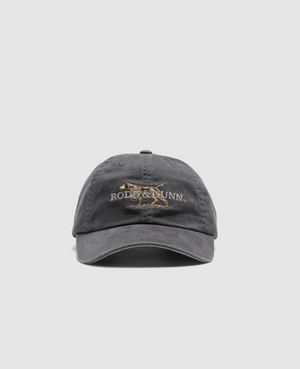 The Rodd & Gunn Double Barrel Cap is a gray cotton twill baseball hat with a worn look, centered with a dog's embroidered logo and "Rodd & Gunn" text on the front against a white background.