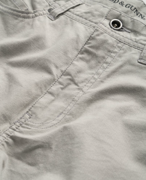 Close-up of Rodd & Gunn Straight Fit Jean in light grey, highlighting the front pocket area. The stitching detail and metal rivets are visible, giving a casual and durable appearance. The stretch fabric enhances comfort, and the texture of the material suggests a cotton blend. YKK zip fly adds to its durability.
