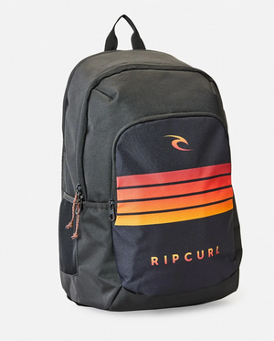 The Rip Curl Ozone 30L School Backpack in black is made from recycled polyester and has a front pocket with orange to red gradient stripes and a wave logo above the white brand name. It features an insulated cooler compartment, top handle, and two side pockets.