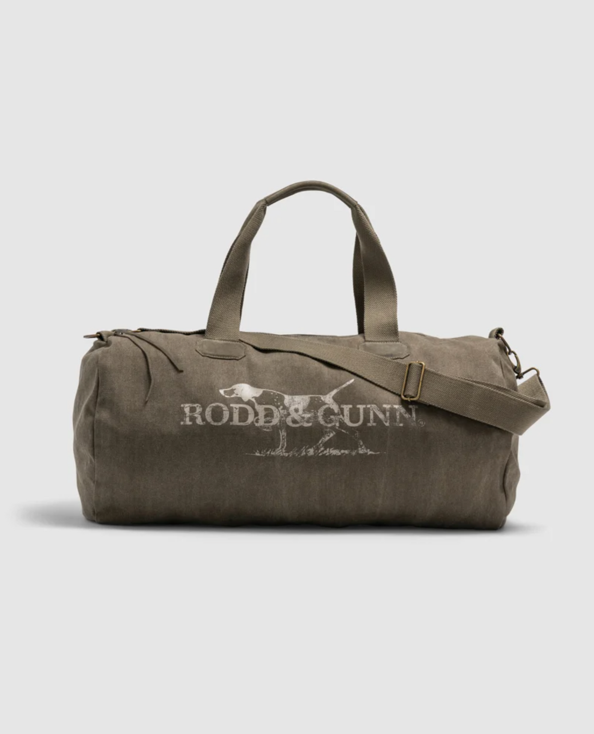 A Rodd & Gunn Double Barrel Duffle Bag, large and khaki, crafted from durable cotton canvas with white branding on the side. It includes two handles and an adjustable shoulder strap, shown on a plain light gray background.