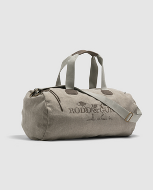 A light grey Rodd & Gunn Double Barrel Duffle Bag made from cotton canvas with dark grey straps and a shoulder strap showcases "Rodd & Gunn" branding elegantly on a plain white background.