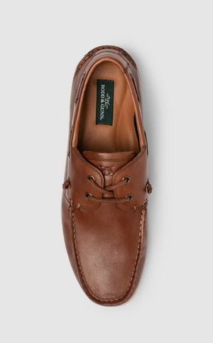 Top view of a single Rodd & Gunn Gordons Bay brown leather boat shoe with laces, a durable rubber outsole, side stitching details, and visible branding on the insole against a neutral gray background.