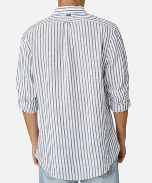 A person is seen from behind wearing Industrie The Feliz Shirt, a classic fit, long-sleeved white shirt with thin vertical blue stripes made of 100% linen. Sleeves are rolled to the elbows and paired with light blue jeans against a plain white backdrop.
