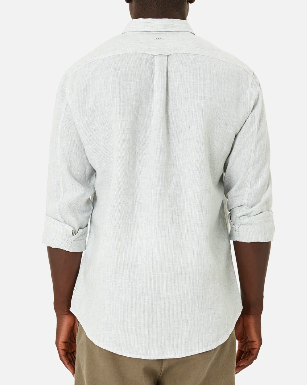 Rear view of a person wearing the Industrie The Rochecroft Shirt in light gray, a relaxed fit long-sleeve button-up shirt. The sleeves of the shirt are rolled up to just below the elbows. The individual is also wearing brown pants against a plain white background.